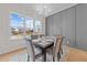 Dining room with panel molding detail, large windows and modern chandelier. Seats six at 820 Willow Tower Ct # 153, Rolesville, NC 27571