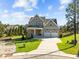 Exterior of a two-story home with a well-manicured lawn and a three-car garage at 820 Willow Tower Ct # 153, Rolesville, NC 27571