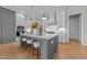 Bright kitchen features large island with seating and a gas range with modern stainless steel hood at 820 Willow Tower Ct # 153, Rolesville, NC 27571