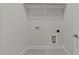 Laundry room features gray tile floor, white walls, and hookups for washer and dryer at 820 Willow Tower Ct # 153, Rolesville, NC 27571