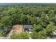 Aerial view of a newly built home surrounded by lush greenery with a glimpse of ongoing construction nearby at 4123 Rockingham Dr, Raleigh, NC 27609