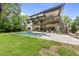 A modern in-ground pool and backyard of a luxurious, multi-level home with ample outdoor living space at 4123 Rockingham Dr, Raleigh, NC 27609