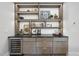 Attractive home bar setup with cabinets, countertop, shelving, and wine refrigerator at 4123 Rockingham Dr, Raleigh, NC 27609