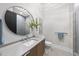 Modern bathroom featuring a round mirror, vessel sink, and glass walk-in shower at 4123 Rockingham Dr, Raleigh, NC 27609
