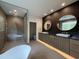 A modern bathroom featuring a double sink vanity, soaking tub, and glass enclosed shower at 4123 Rockingham Dr, Raleigh, NC 27609