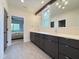 Bathroom featuring double sink vanity, modern hardware, and elegant tile flooring at 4123 Rockingham Dr, Raleigh, NC 27609