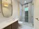 Sleek bathroom featuring a glass-enclosed shower and modern vanity with stylish mirror at 4123 Rockingham Dr, Raleigh, NC 27609