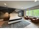Modern bedroom features a platform bed, unique wall design and a seating area with views at 4123 Rockingham Dr, Raleigh, NC 27609