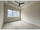 Unfinished bedroom features a ceiling fan and a large window, offering ample natural light and backyard views at 4123 Rockingham Dr, Raleigh, NC 27609