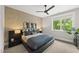 Modern bedroom with a large bed, decorative wall art, and large bright window at 4123 Rockingham Dr, Raleigh, NC 27609