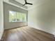 Bright bedroom featuring a tray ceiling, hardwood floors, recessed lighting and a large window at 4123 Rockingham Dr, Raleigh, NC 27609