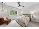 Cozy bedroom featuring a floral-patterned bed, ceiling fan and natural light from a window at 4123 Rockingham Dr, Raleigh, NC 27609