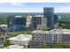 A cityscape view features office buildings in the background with greenery in the foreground at 4123 Rockingham Dr, Raleigh, NC 27609