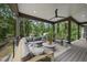 Inviting covered deck area with comfortable seating and ceiling fan at 4123 Rockingham Dr, Raleigh, NC 27609
