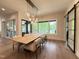 Airy dining room featuring a modern chandelier, large windows, and a spacious table at 4123 Rockingham Dr, Raleigh, NC 27609