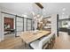 Bright dining room with a modern light fixture, a view of the butler's pantry, and sliding doors at 4123 Rockingham Dr, Raleigh, NC 27609