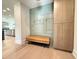 Inviting entryway featuring a built-in bench and cabinets with a pale green paneled wall at 4123 Rockingham Dr, Raleigh, NC 27609