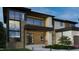 Striking modern home showcasing a blend of brick, wood, and stone accents, featuring a well-manicured lawn and elegant landscaping at 4123 Rockingham Dr, Raleigh, NC 27609
