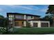Striking exterior featuring modern architecture, a two-car garage, and lush landscaping in twilight at 4123 Rockingham Dr, Raleigh, NC 27609