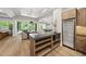 Open layout with a bar, game tables, refrigerator, backyard access, and recessed lighting at 4123 Rockingham Dr, Raleigh, NC 27609