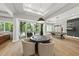 Entertainment space with card table, pool table, backyard access, and abundant natural light at 4123 Rockingham Dr, Raleigh, NC 27609