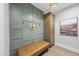 Stylish hallway featuring custom wall paneling, bench seat, and storage cabinet at 4123 Rockingham Dr, Raleigh, NC 27609