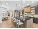 Modern kitchen features a large island with barstool seating, stainless appliances, and pendant lighting at 4123 Rockingham Dr, Raleigh, NC 27609