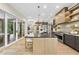 Bright modern kitchen features hardwood floors, stainless appliances, and sliding doors to the backyard at 4123 Rockingham Dr, Raleigh, NC 27609