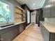 Stylish kitchen with dark modern cabinets, stainless steel appliances, and floating shelves at 4123 Rockingham Dr, Raleigh, NC 27609