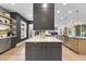 Modern kitchen boasts an island with seating, stainless appliances, and custom cabinets with lighting at 4123 Rockingham Dr, Raleigh, NC 27609