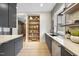 Modern kitchen boasts stainless appliances, floating shelves with lighting, and a view of the backyard at 4123 Rockingham Dr, Raleigh, NC 27609