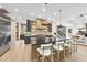 Open concept kitchen with a large island, barstool seating, stainless appliances, and custom cabinets at 4123 Rockingham Dr, Raleigh, NC 27609