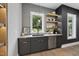 Wet bar features custom cabinets, floating shelves with lighting, stainless appliances, and a window view at 4123 Rockingham Dr, Raleigh, NC 27609