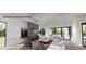 Bright living room featuring a fireplace with stone surround, modern furniture and large windows offering scenic outdoor views at 4123 Rockingham Dr, Raleigh, NC 27609