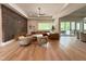 Expansive living room with large windows, hardwood floors, and a comfortable sectional sofa at 4123 Rockingham Dr, Raleigh, NC 27609