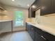 Modern mud room featuring dark cabinetry, a white countertop, and natural lighting at 4123 Rockingham Dr, Raleigh, NC 27609