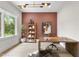 Stylish home office featuring a wooden desk, decorative shelving, and a large window at 4123 Rockingham Dr, Raleigh, NC 27609