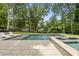 Relaxing pool and spa surrounded by lush landscaping and plenty of space to sunbathe at 4123 Rockingham Dr, Raleigh, NC 27609