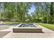 Beautiful pool with attached spa surrounded by lush greenery and luxury finishes at 4123 Rockingham Dr, Raleigh, NC 27609