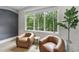 Cozy sitting area with comfortable chairs and a large window with a wooded view at 4123 Rockingham Dr, Raleigh, NC 27609