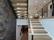 Modern staircase with wood treads, sleek railings, and an interesting accent wall at 4123 Rockingham Dr, Raleigh, NC 27609
