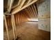 Unfinished attic showing exposed wooden beams and plywood flooring, offering potential for future use at 165 Inspiration Way, Fuquay Varina, NC 27526