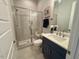 Well-lit bathroom featuring a modern shower and vanity at 165 Inspiration Way, Fuquay Varina, NC 27526