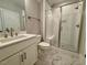 Well-lit bathroom featuring a modern shower and vanity at 165 Inspiration Way, Fuquay Varina, NC 27526