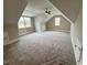 Expansive bonus room with cozy gray carpet, natural light and ceiling fan, perfect for versatile living at 165 Inspiration Way, Fuquay Varina, NC 27526