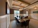 Dining room with decorative chandelier, wainscoting, and a large window at 165 Inspiration Way, Fuquay Varina, NC 27526