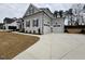 Attractive house featuring a spacious three-car garage and concrete driveway at 165 Inspiration Way, Fuquay Varina, NC 27526