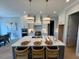 Modern kitchen with large center island, stainless steel appliances, and stylish pendant lighting at 165 Inspiration Way, Fuquay Varina, NC 27526