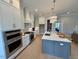 Kitchen featuring stainless steel appliances, lots of cabinets and center island with chairs at 165 Inspiration Way, Fuquay Varina, NC 27526