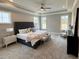 Bright, spacious main bedroom featuring plush carpeting, a ceiling fan, and several windows at 165 Inspiration Way, Fuquay Varina, NC 27526